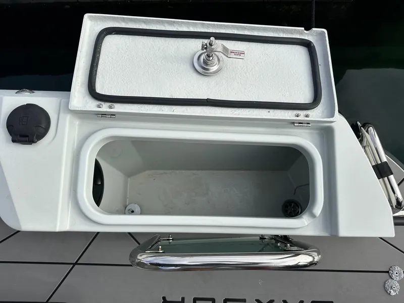 Slide: The Image of Saxdor 200S 2022 boat storage compartment with open lid and stainless steel handle. - 7