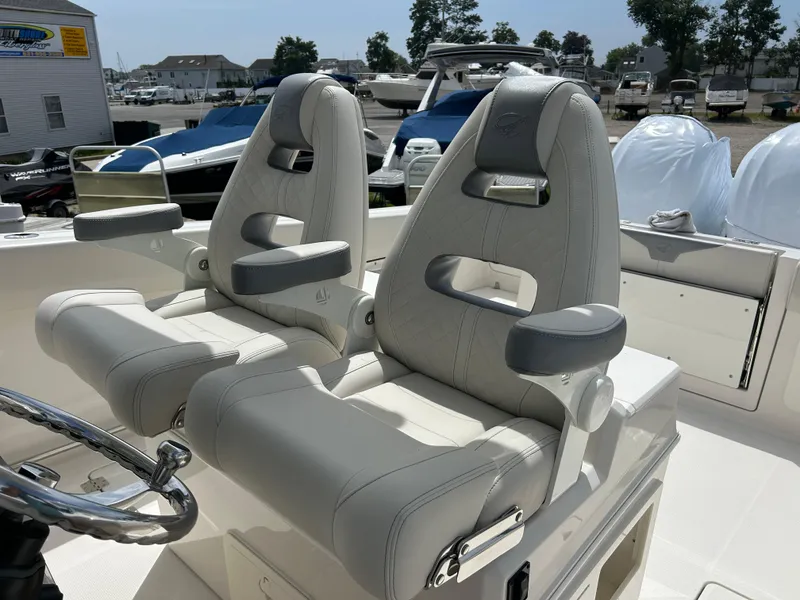 Slide: The Image of 2025 Sailfish 312 CC boat seats, luxurious design, marina background. - 16