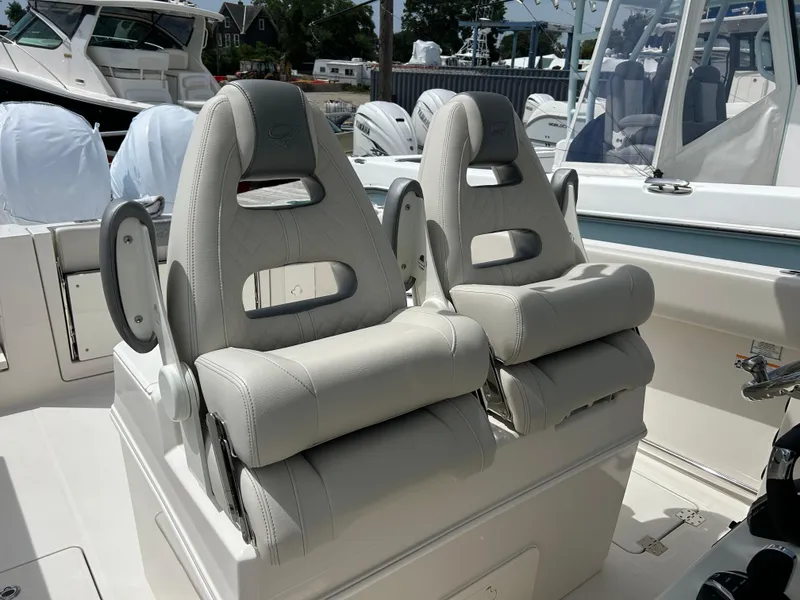 Slide: The Image of 2025 Sailfish 312 CC boat with dual cushioned seats in cockpit area. - 18