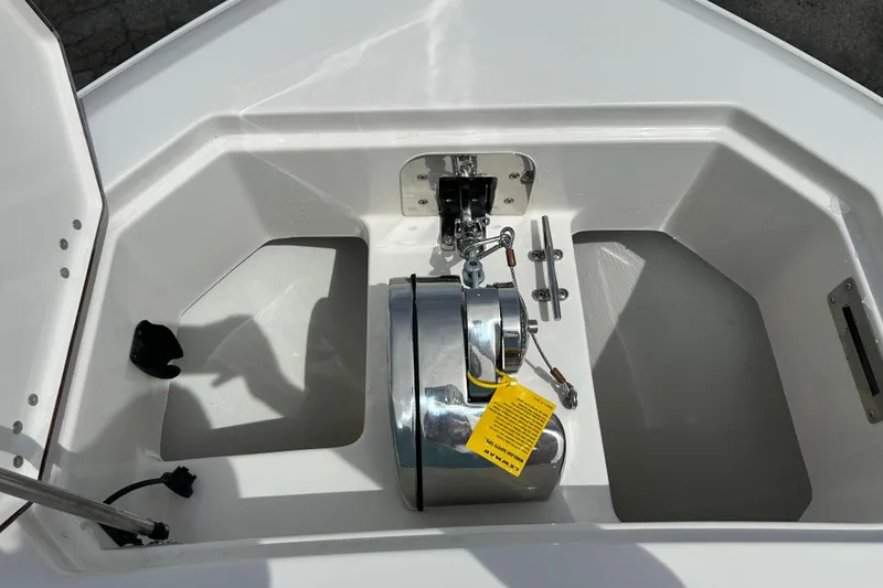 Slide: The Image of 2025 Sailfish 312 CC boat anchor compartment with winch and storage. - 2
