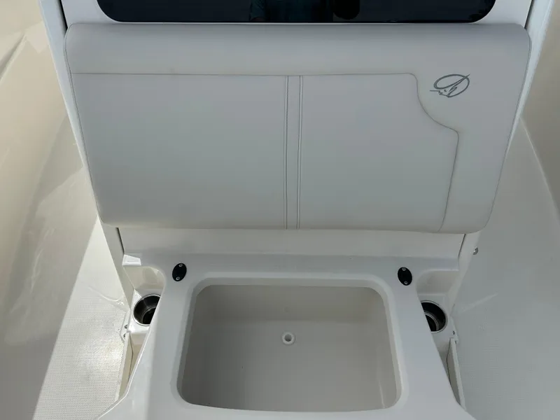 Slide: The Image of 2025 Sailfish 312 CC boat interior with storage compartment and cup holders. - 21
