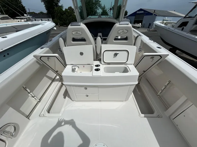 Slide: The Image of 2025 Sailfish 312 CC boat interior with open storage compartments and seating. - 23