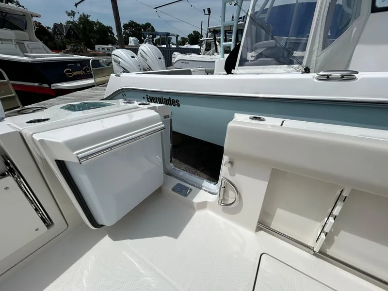 Slide: The Image of 2025 Sailfish 312 CC boat interior with open storage compartment and sleek design. - 24