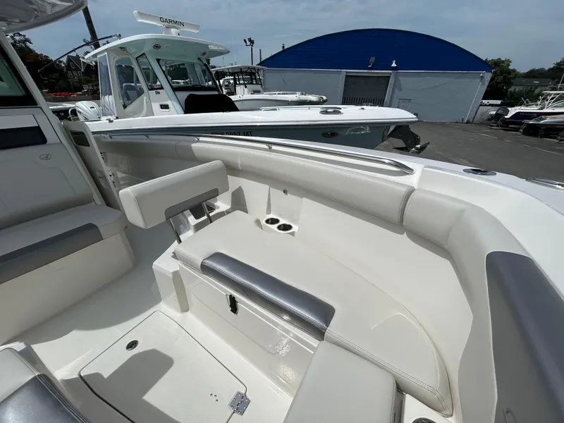 Slide: The Image of 2025 Sailfish 312 CC boat interior with white seating and storage compartments. - 7