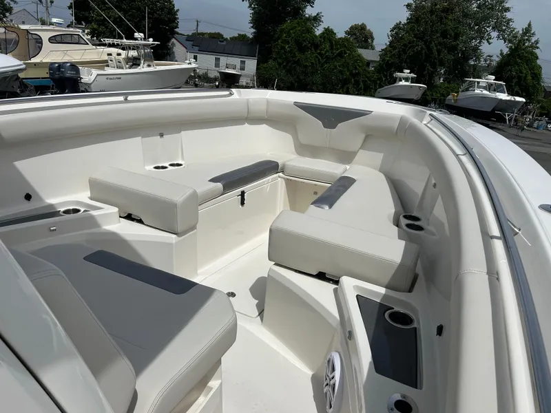 Slide: The Image of 2025 Sailfish 312 CC boat interior with cushioned seating and cup holders. - 8