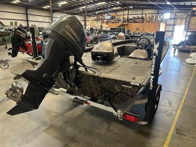 Slide: The Image of 2025 Xpress XP170 boat with Yamaha 70 engine in warehouse setting. - 4