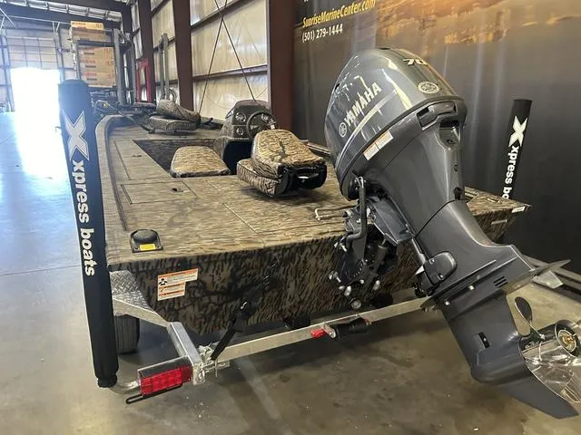 Slide: The Image of 2025 Xpress XP170 boat with Yamaha 70 engine in a showroom. - 5