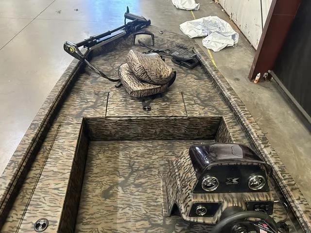 Slide: The Image of 2025 Xpress XP170 boat with Yamaha 70, camo interior, and steering console. - 6