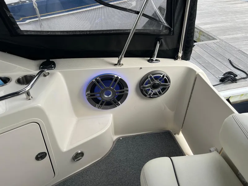 Slide: The Image of Interior of 2000 Sea Ray 240 Sundancer boat with speakers and seating. - 10