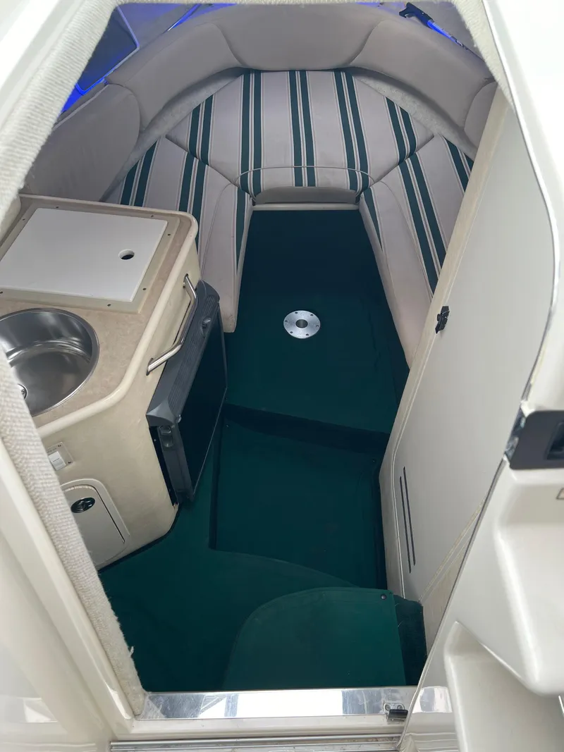 Slide: The Image of Interior of 2000 Sea Ray 240 Sundancer with kitchenette and seating area. - 12