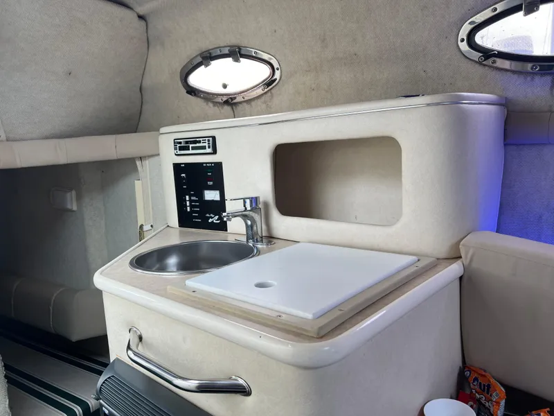 Slide: The Image of Interior of 2000 Sea Ray 240 Sundancer boat with kitchenette and sink. - 13
