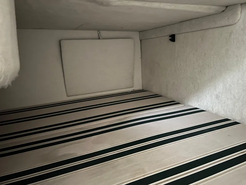 Slide: The Image of Interior cabin of 2000 Sea Ray 240 Sundancer with striped upholstery. - 14