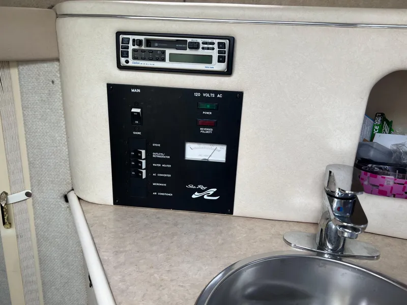 Slide: The Image of Control panel and sink inside 2000 Sea Ray 240 Sundancer boat cabin. - 16