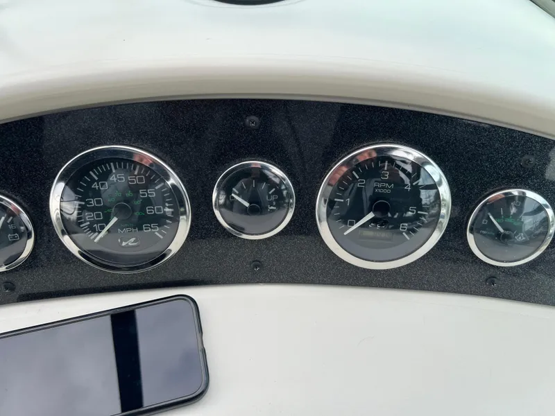 Slide: The Image of Dashboard of 2000 Sea Ray 240 Sundancer with gauges and smartphone. - 17