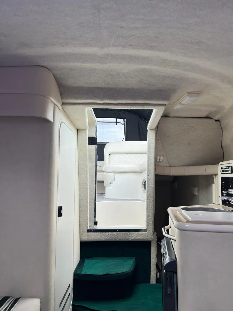 Slide: The Image of Interior of 2000 Sea Ray 240 Sundancer boat, featuring compact cabin amenities. - 19