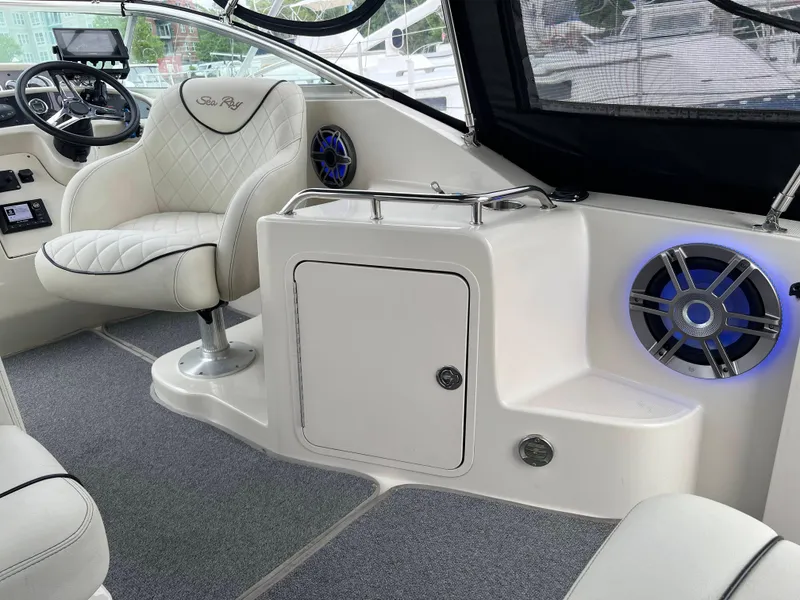 Slide: The Image of Interior of 2000 Sea Ray 240 Sundancer boat with plush seating and modern controls. - 20
