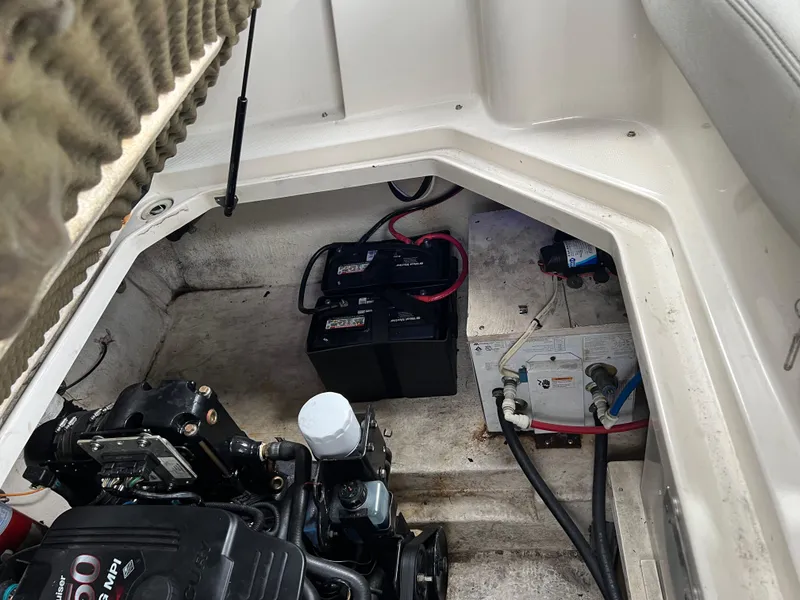 Slide: The Image of Engine compartment of 2000 Sea Ray 240 Sundancer with battery and wiring visible. - 22