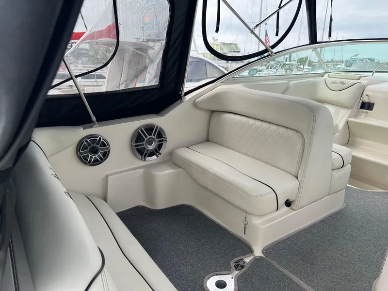 Slide: The Image of Interior of 2000 Sea Ray 240 Sundancer with cushioned seating and speakers. - 3