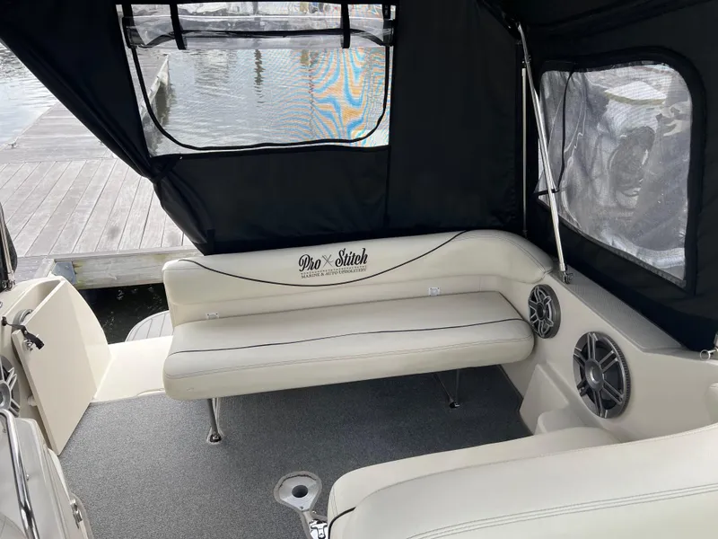 Slide: The Image of Interior of 2000 Sea Ray 240 Sundancer boat with seating and speakers. - 4