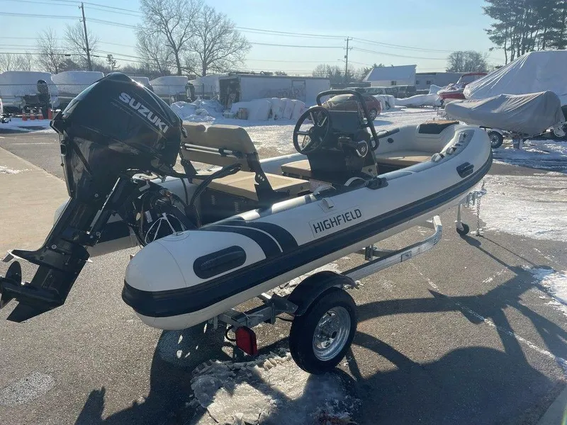 Slide: The Image of 2025 Highfield CL360 GT SE boat on trailer, parked outside industrial building. - 4