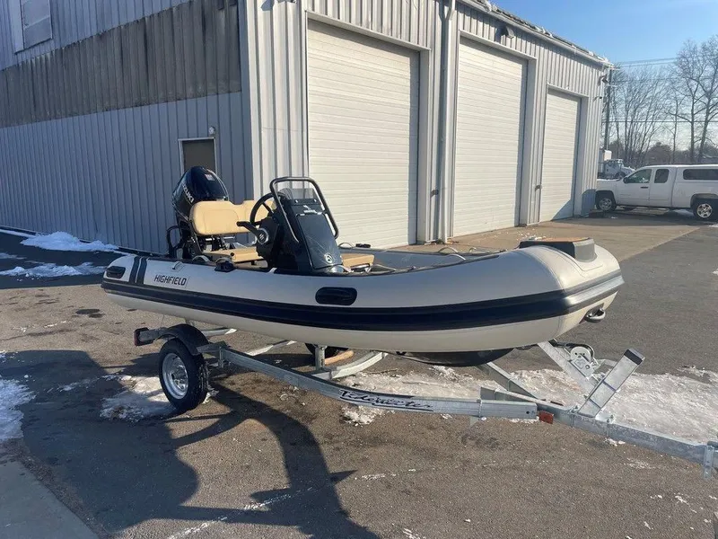 Slide: The Image of 2025 Highfield CL360 GT SE boat interior with Suzuki engine and beige seating. - 6