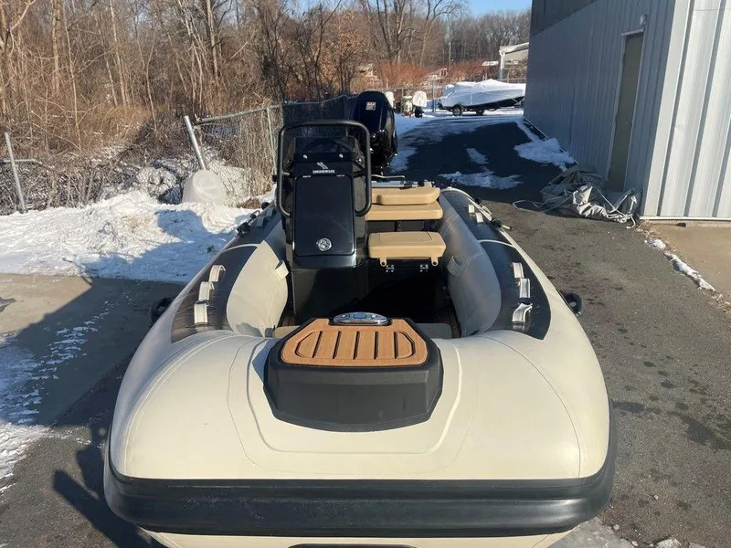 Slide: The Image of 2025 Highfield CL360 GT SE inflatable boat interior with cushioned seating and wood-style flooring. - 12