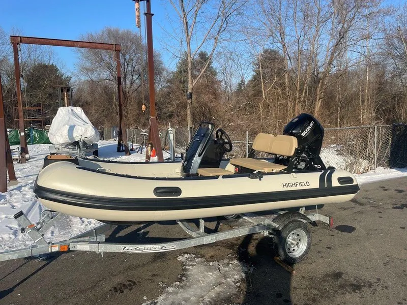 Slide: The Image of 2025 Highfield CL360 GT SE boat, interior view, parked outdoors in a snowy setting. - 2