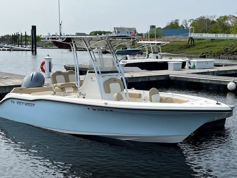 Slide: The Image of 2020 Key West 219fs boat docked in a marina, calm water, clear sky. - 11