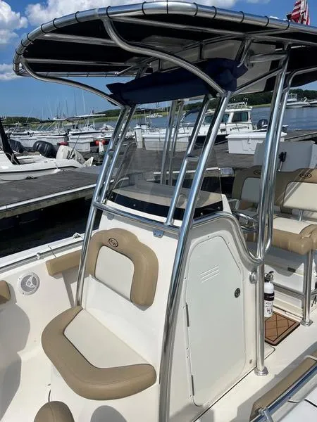 Slide: The Image of 2020 Key West 219fs boat with T-top and seating, docked at marina. - 6