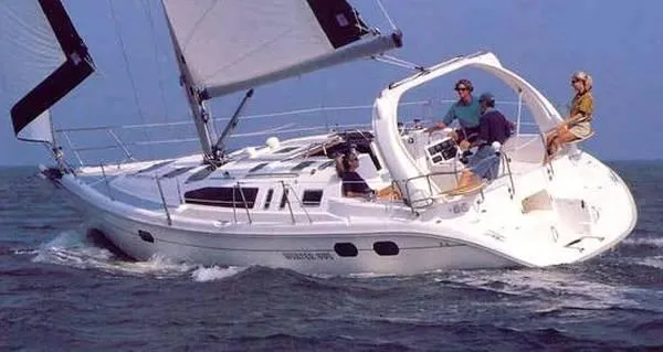 The Image of 1999 Hunter 380 sailboat navigating the ocean with crew onboard. - 1