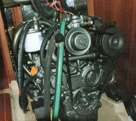 Slide: The Image of Engine of 1999 Hunter 380 sailboat, showcasing mechanical components and hoses. - 12