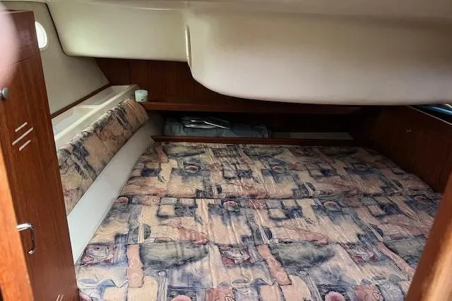 Slide: The Image of Cozy cabin interior of 1999 Hunter 380 sailboat with patterned bedding. - 21
