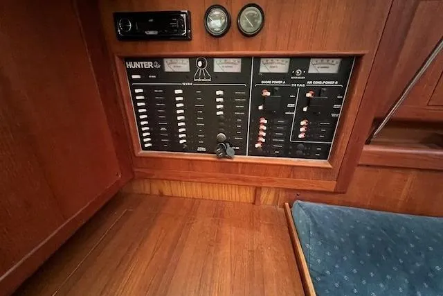 Slide: The Image of Control panel of a 1999 Hunter 380 sailboat with wood finish and blue upholstery. - 22