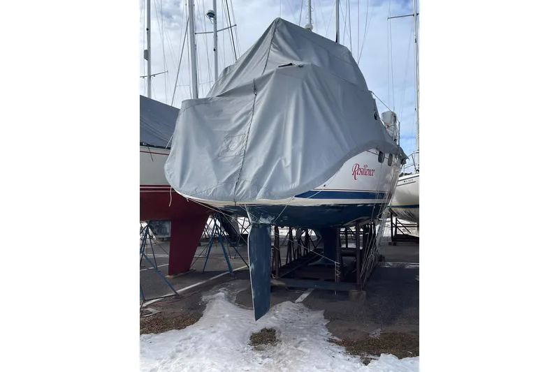 Slide: The Image of Covered 1999 Hunter 380 sailboat named "Resilience" on stands, winter storage setting. - 30