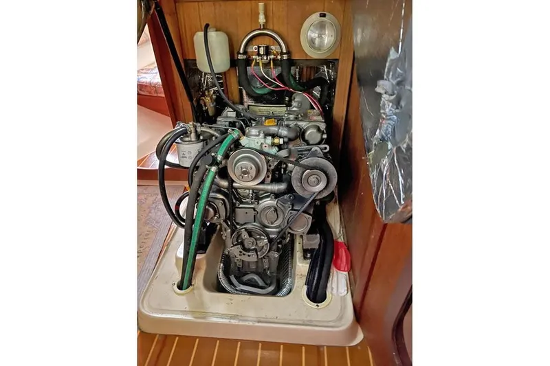 Slide: The Image of Engine compartment of a 1999 Hunter 380 sailboat, showcasing mechanical components and wiring. - 40