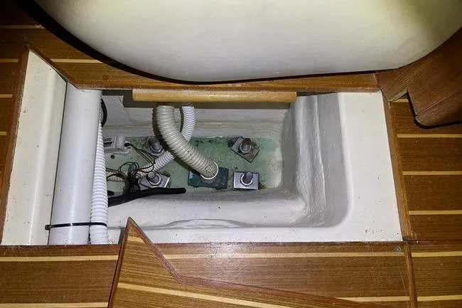 Slide: The Image of Interior view of a 1999 Hunter 380 sailboat showing plumbing and wiring components. - 41