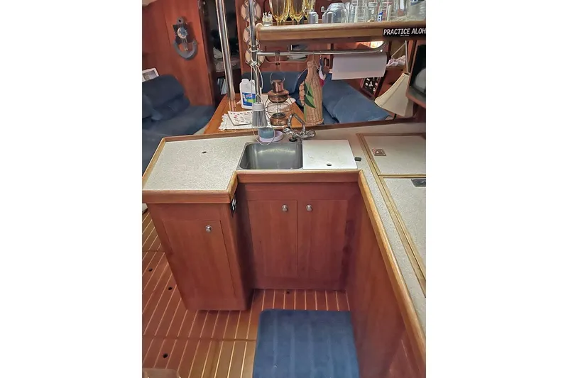Slide: The Image of Interior of 1999 Hunter 380 sailboat kitchen with wooden cabinets and sink. - 46