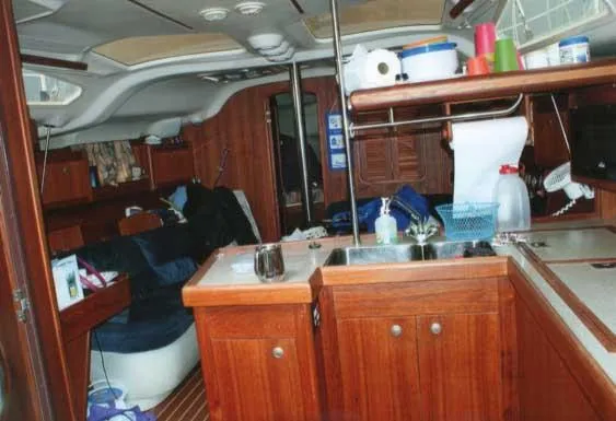 Slide: The Image of Interior of 1999 Hunter 380 sailboat with wooden cabinetry and kitchen area. - 5