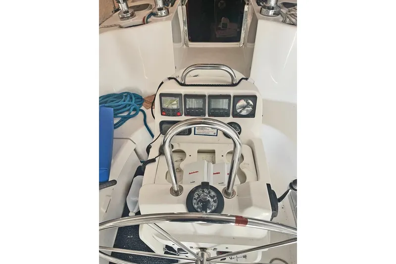Slide: The Image of Cockpit of 1999 Hunter 380 sailboat with navigation instruments and steering wheel. - 51