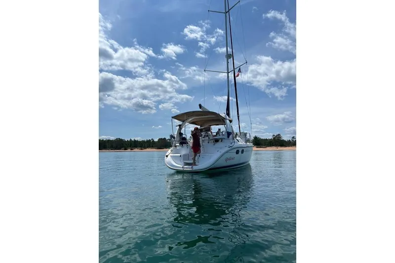 Slide: The Image of Sailboat on calm water, Hunter 380, 1999 model, under a clear blue sky. - 54