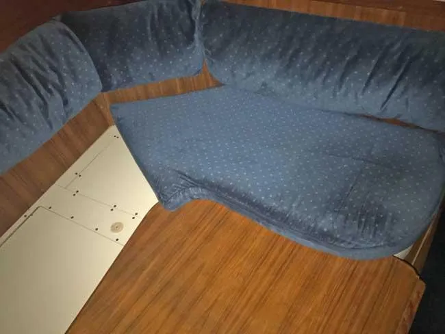 Slide: The Image of 1999 Hunter 380 interior with blue cushioned seating and wooden finish. - 7