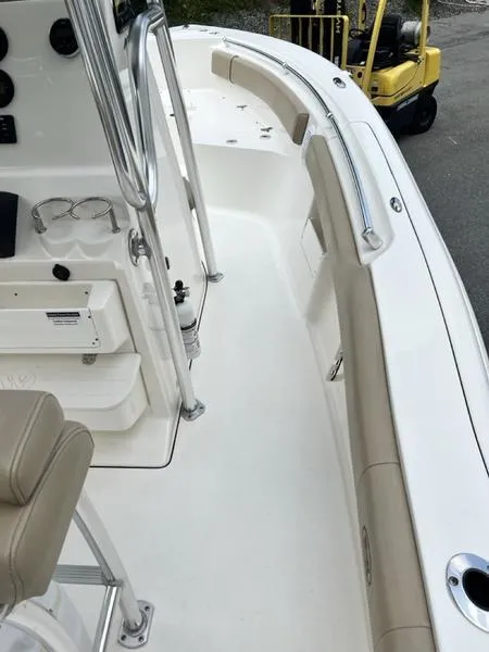 Slide: The Image of 2019 Key West 239FS boat interior with beige seating and stainless steel fixtures. - 3