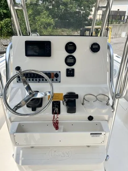 Slide: The Image of 2019 Key West 239FS boat console with steering wheel and gauges. - 5