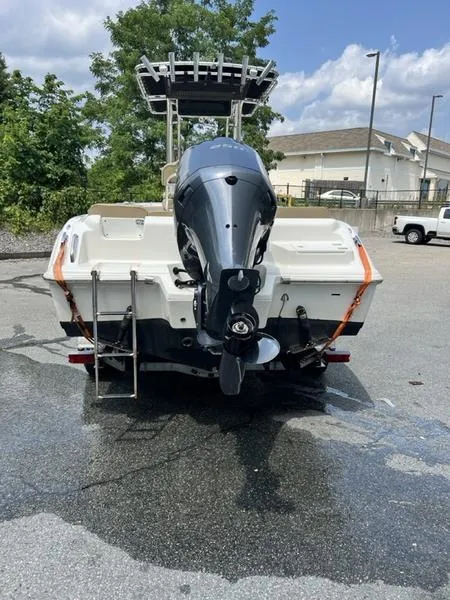 Slide: The Image of 2019 Key West 239FS boat with outboard motor in parking lot. - 6