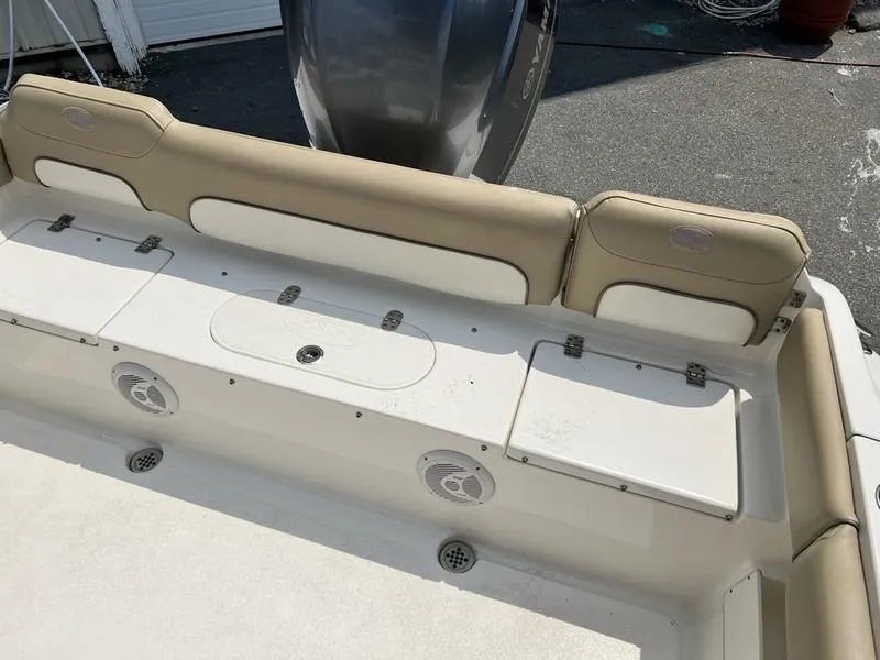 Slide: The Image of 2019 Key West 239FS boat interior with beige seating and storage compartments. - 7