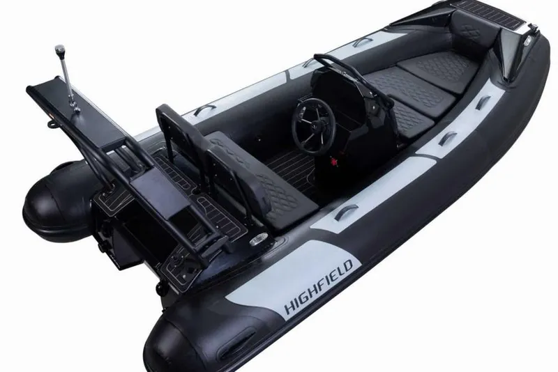The Image of 2025 Highfield Sport390 inflatable boat, black and white design, steering console, and seating. - 2