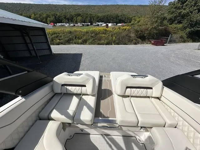 Slide: The Image of 2025 Regal LS6 boat interior with luxurious white seating and scenic outdoor view. - 11