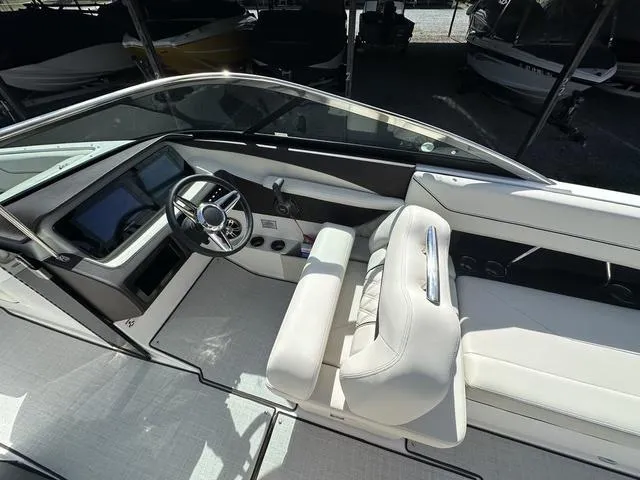 Slide: The Image of 2025 Regal LS6 boat interior with sleek dashboard and white seating. - 16