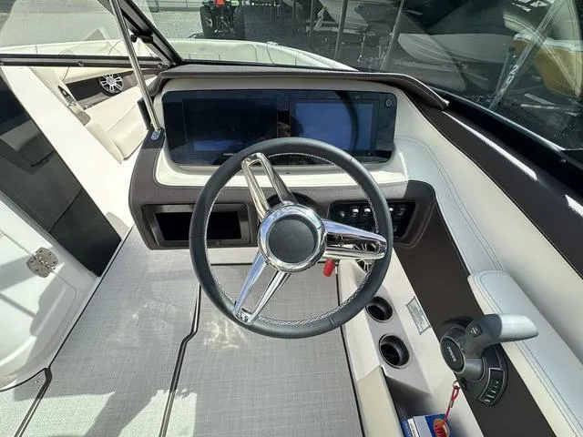 Slide: The Image of 2025 Regal LS6 boat cockpit with modern steering wheel and dashboard controls. - 17