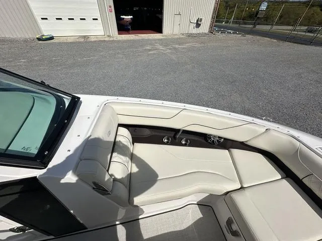 Slide: The Image of 2025 Regal LS6 boat interior with beige seating and cup holders. - 20